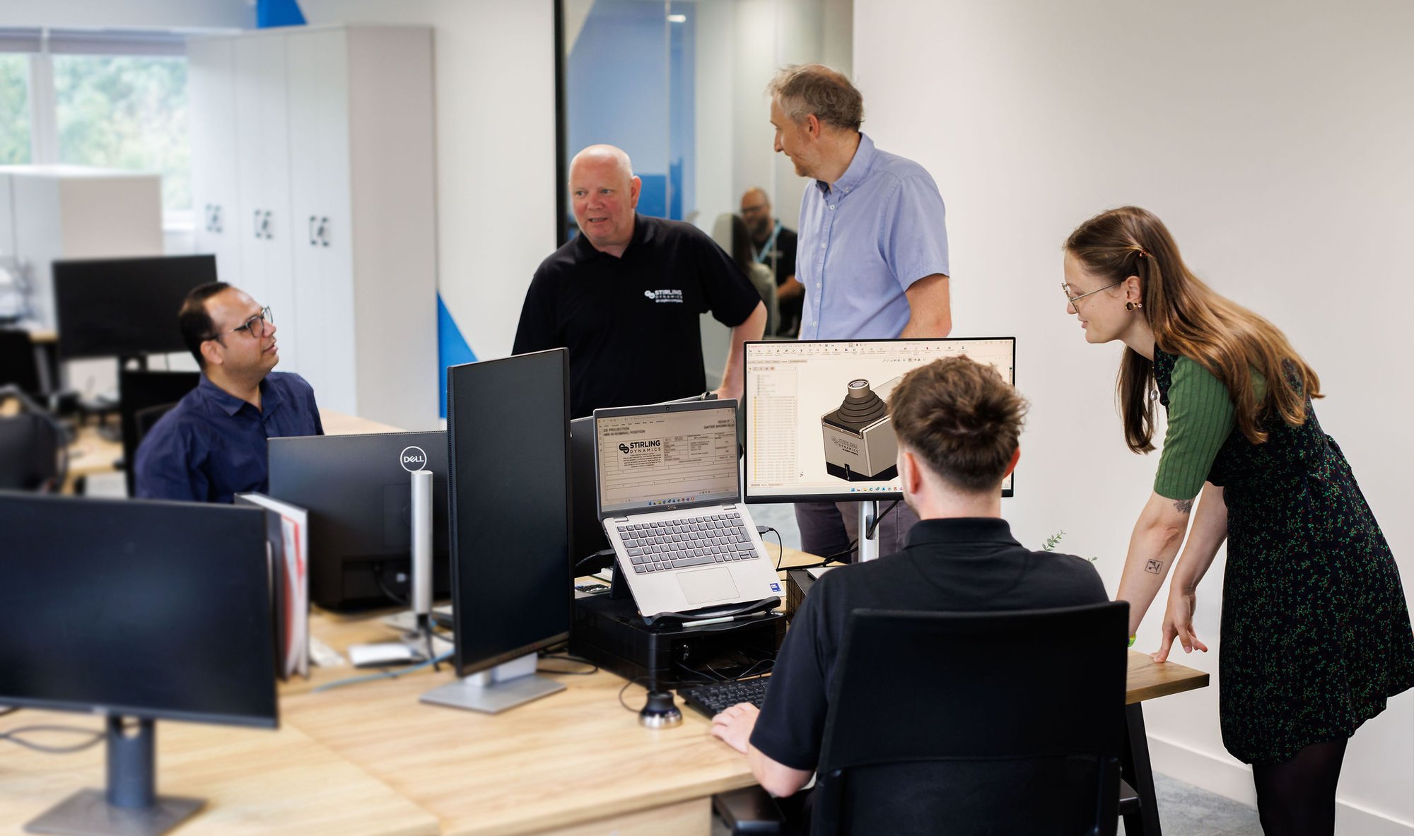 Stirling-Dynamics-engineers-discussing-cockpit-controls-design-on-screen